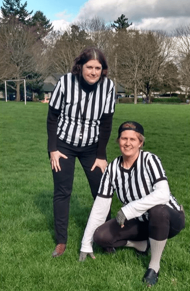 Picture of staff dressed as referees in a park